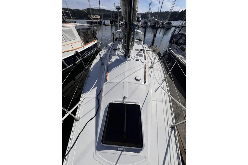 Slide: The Image of 1981 Nordic Boats 40 sailboat docked at marina, showcasing deck and rigging. - 10