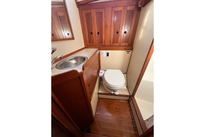 Slide: The Image of 1981 Nordic Boats 40 bathroom with wooden cabinets, sink, and toilet. - 40