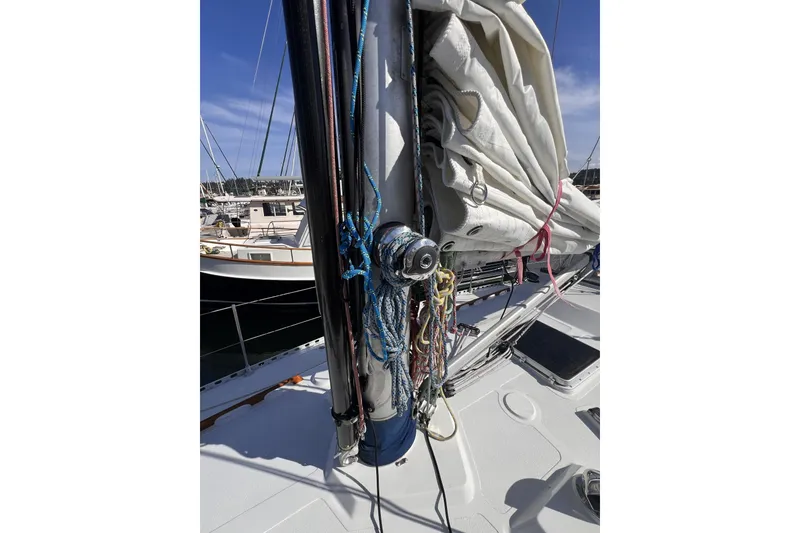 Slide: The Image of 1981 Nordic Boats 40 sailboat mast with rigging and sails in a marina. - 12