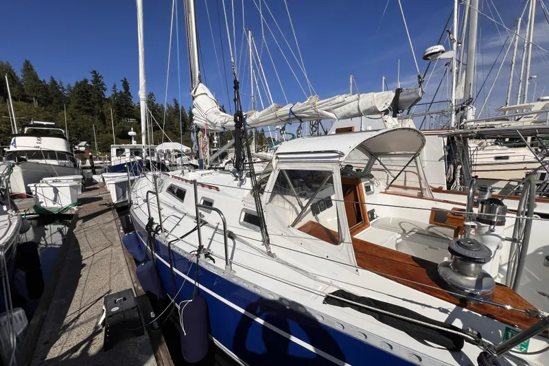 Slide: The Image of 1981 Nordic Boats 40 sailboat docked at marina, surrounded by other vessels. - 6