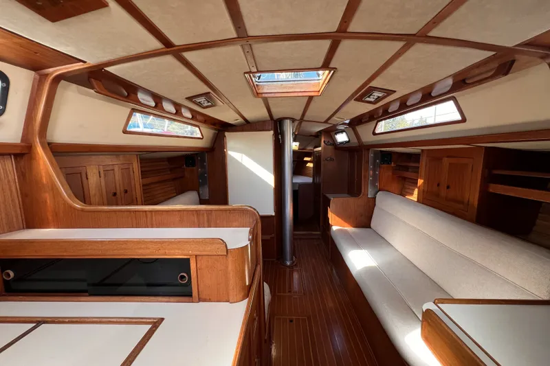 Slide: The Image of Interior of 1981 Nordic Boats 40, featuring wooden cabinetry and beige seating. - 34