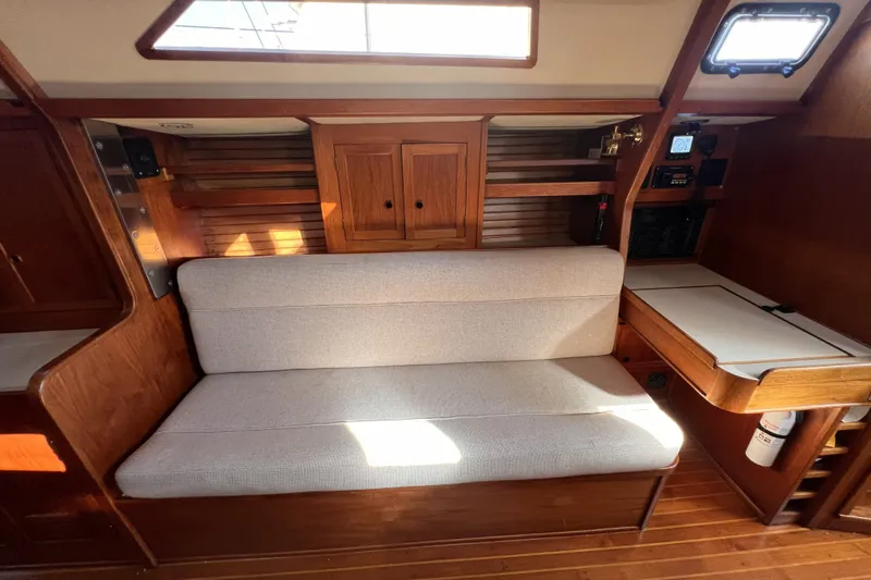 Slide: The Image of Interior of 1981 Nordic Boats 40, featuring wooden cabinetry and a cushioned bench. - 41