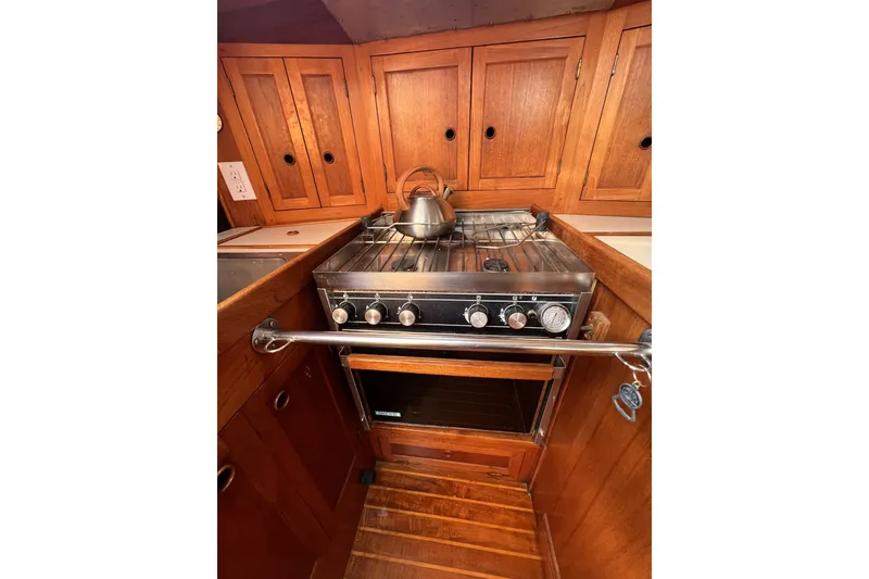 Slide: The Image of Wooden kitchen interior of 1981 Nordic Boats 40, featuring stove and cabinets. - 47