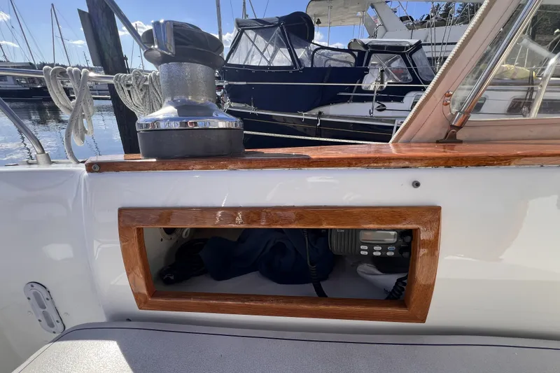 Slide: The Image of 1981 Nordic Boats 40 sailboat cockpit with winch and radio, docked at marina. - 22
