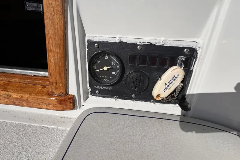 Slide: The Image of Control panel of a 1981 Nordic Boats 40 with Yanmar gauge and keychain. - 28