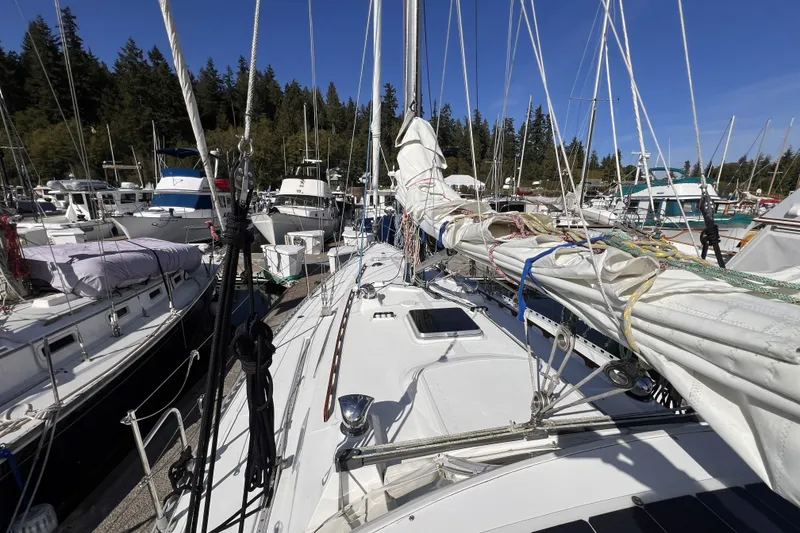 Slide: The Image of 1981 Nordic Boats 40 sailboat docked in a marina, surrounded by other vessels. - 18