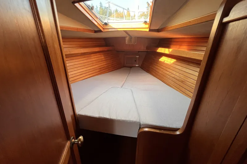 Slide: The Image of Interior cabin of 1981 Nordic Boats 40, featuring wooden paneling and a skylight. - 37