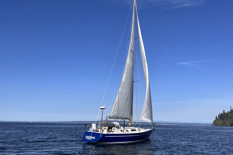 Slide: The Image of 1981 Nordic Boats 40 sailboat on calm blue waters under clear sky. - 4