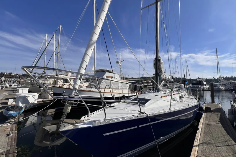 Slide: The Image of 1981 Nordic Boats 40 sailboat docked at marina under clear blue sky. - 5