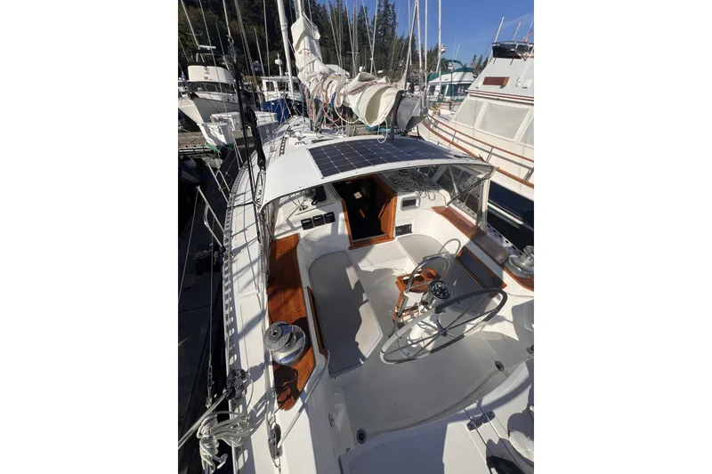 Slide: The Image of 1981 Nordic Boats 40 sailboat with solar panel, docked in marina. - 19