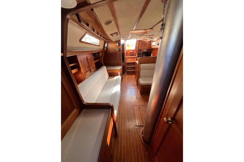 Slide: The Image of Interior of 1981 Nordic Boats 40, featuring wooden finishes and cozy seating. - 35
