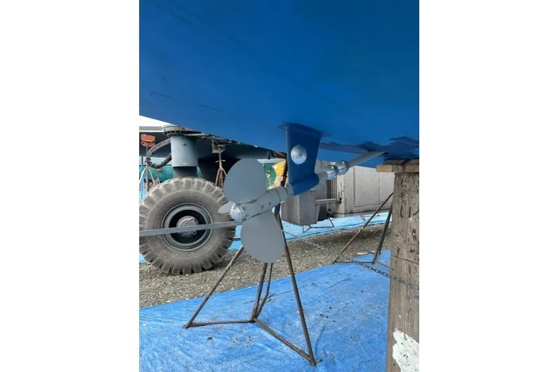 Slide: The Image of Propeller of 1981 Nordic Boats 40 on stand, blue hull, outdoor setting. - 66
