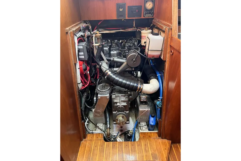 Slide: The Image of Engine compartment of a 1981 Nordic Boats 40, showcasing mechanical components and wiring. - 54