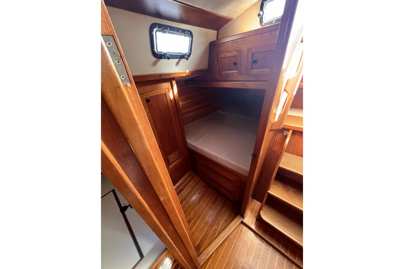 Slide: The Image of Cozy cabin interior of 1981 Nordic Boats 40 with wooden finish and bedding. - 45