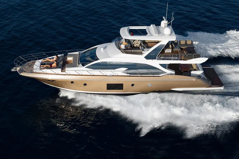 Slide: The Image of 2018 Azimut 66 yacht cruising on open water, showcasing luxury and speed. - 2