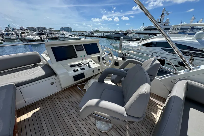 Slide: The Image of Flybridge of 2018 Azimut 66 yacht with helm station and marina view. - 10