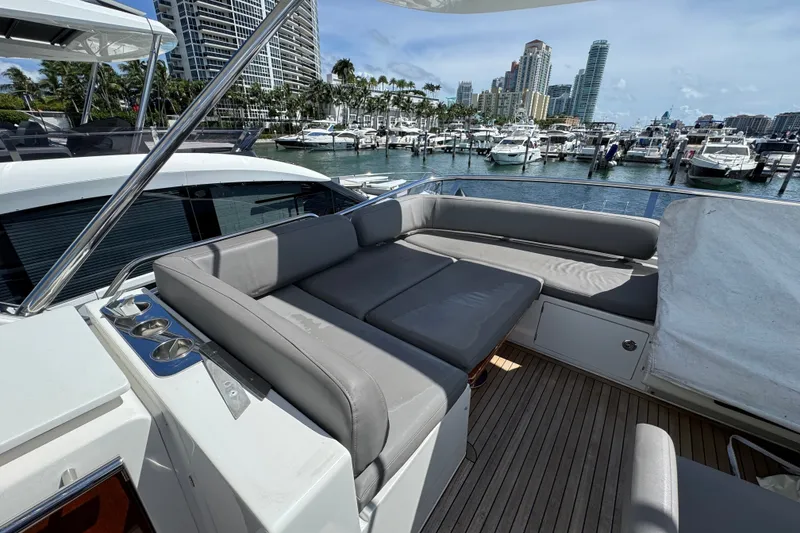 Slide: The Image of Luxurious 2018 Azimut 66 yacht with spacious deck seating at a marina. - 9