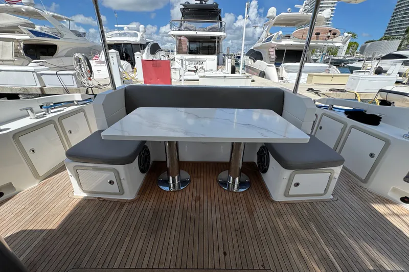 Slide: The Image of Luxury seating area on 2018 Azimut 66 yacht with sleek table and cushioned benches. - 12