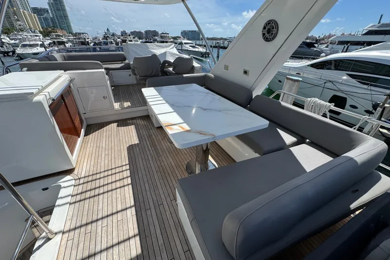 Slide: The Image of Luxurious 2018 Azimut 66 yacht deck with elegant seating and marina view. - 7