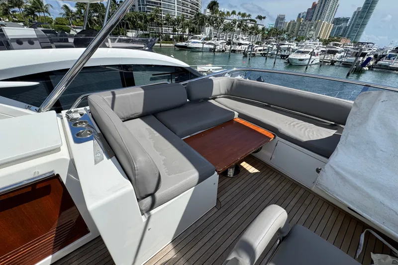 Slide: The Image of Luxurious 2018 Azimut 66 yacht deck with seating and table, docked at marina. - 8