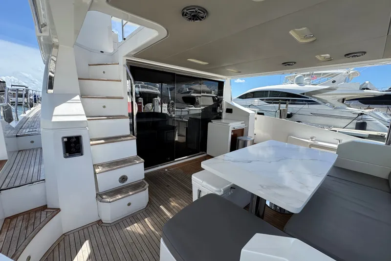 Slide: The Image of Luxurious 2018 Azimut 66 yacht deck with seating, table, and staircase. - 11