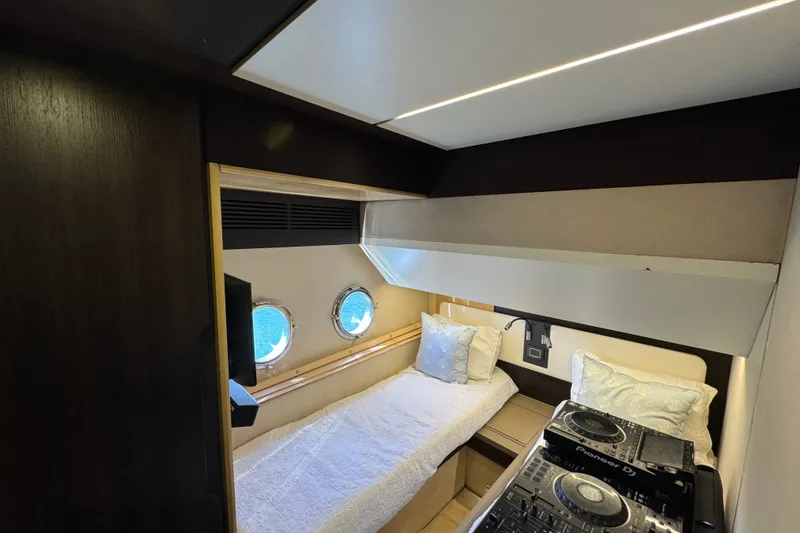 Slide: The Image of Luxurious cabin interior of 2018 Azimut 66 yacht with twin portholes and DJ equipment. - 21