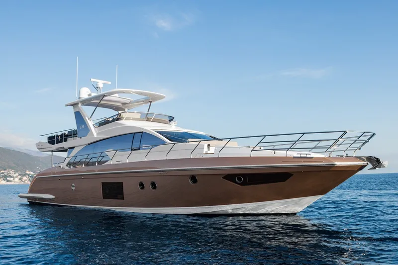 The Image of Luxury 2018 Azimut 66 yacht cruising on open water under clear blue skies. - 4