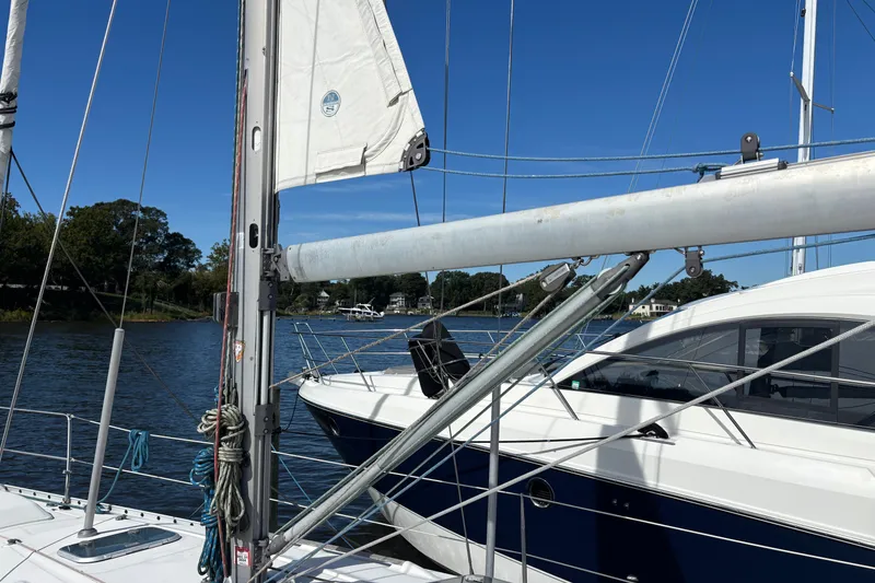 Slide: The Image of Sailboat Beneteau 381 from 1999 docked on a sunny day by the water. - 3