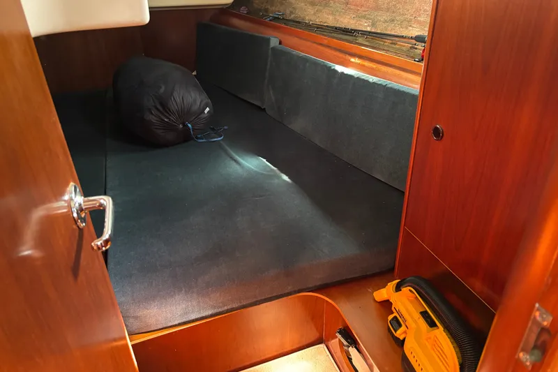 Slide: The Image of Cozy cabin interior of 1999 Beneteau 381 sailboat with storage and equipment. - 22