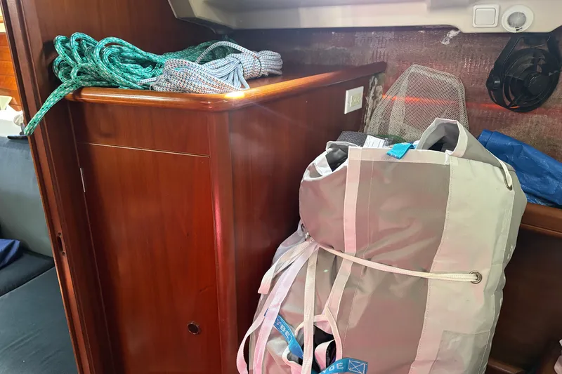 Slide: The Image of Interior of a 1999 Beneteau 381 sailboat with ropes and a storage bag. - 20