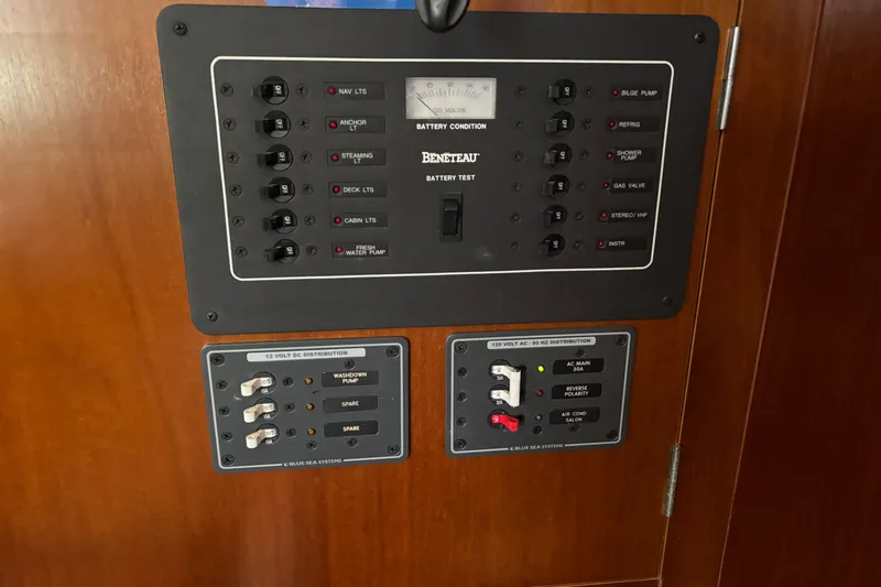 Slide: The Image of Electrical control panel on a 1999 Beneteau 381 sailboat, featuring various switches and gauges. - 13