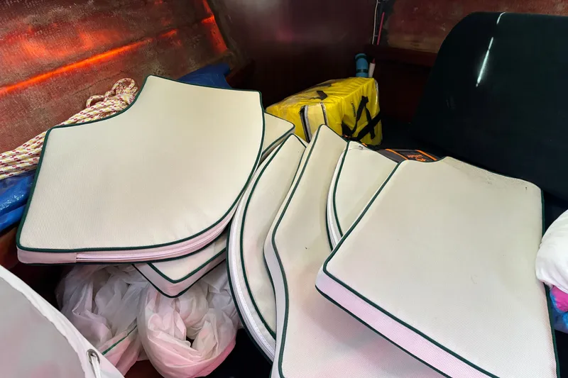 Slide: The Image of Cushions and gear inside a 1999 Beneteau 381 sailboat cabin. - 18