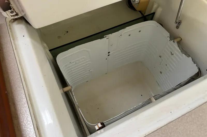 Slide: The Image of Open storage compartment on a 1999 Beneteau 381 sailboat, showing interior details. - 14