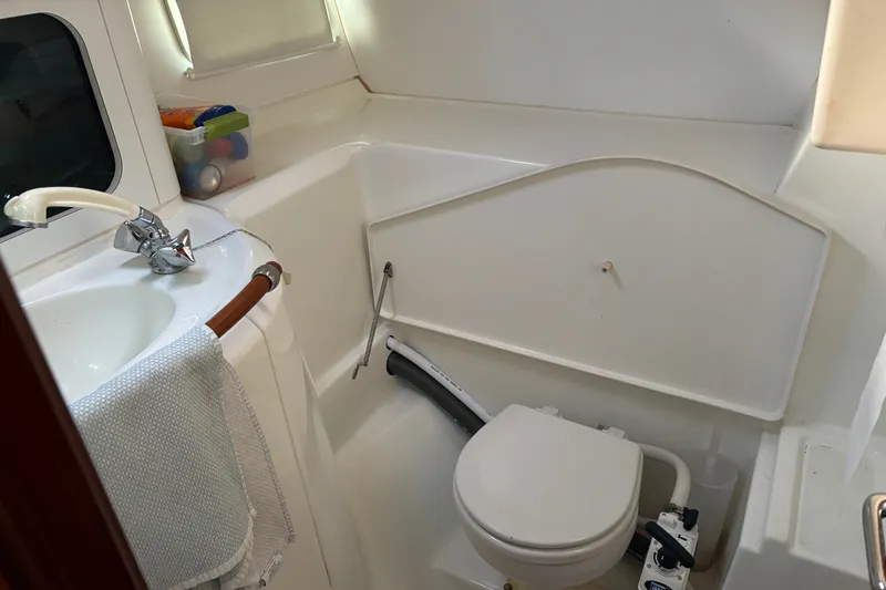 Slide: The Image of 1999 Beneteau 381 yacht bathroom with sink, toilet, and storage space. - 16