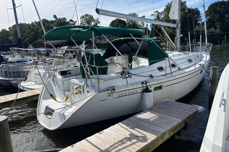 Slide: The Image of Sailboat docked, 1999 Beneteau Oceanis 381, white hull, green canopy, marina setting. - 0