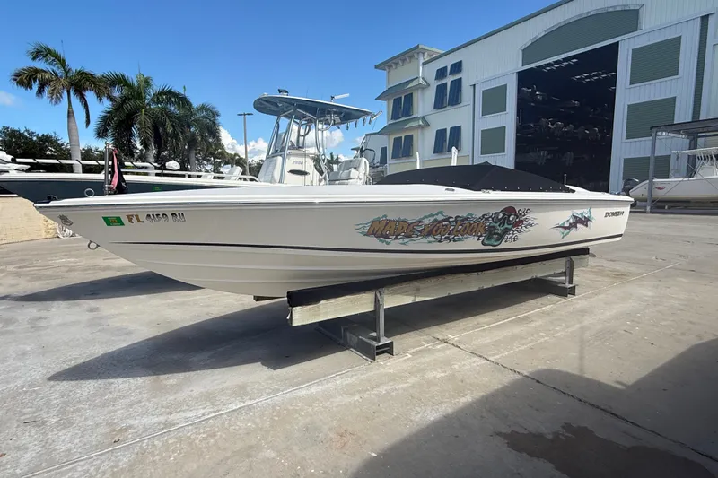The Image of 2018 Donzi 22 Classic boat on display, featuring custom graphics, parked outdoors. - 0