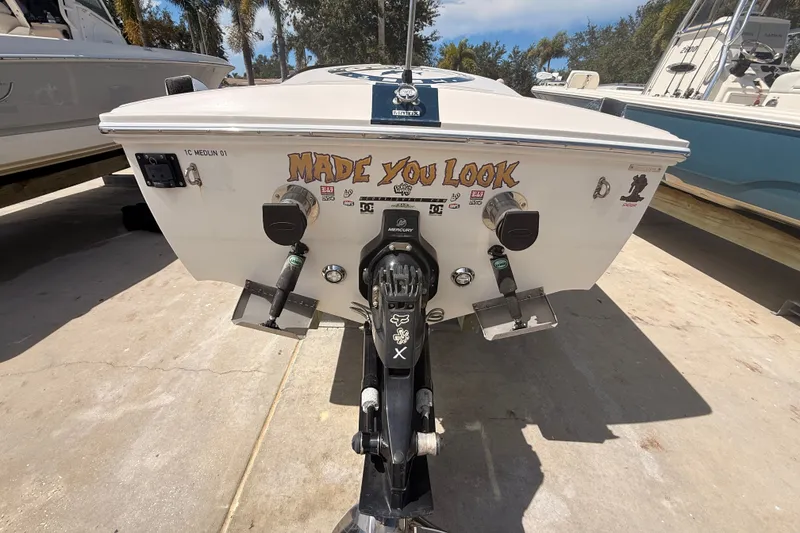 Slide: The Image of 2018 Donzi 22 Classic boat stern with "Made You Look" decal and outboard motor. - 13