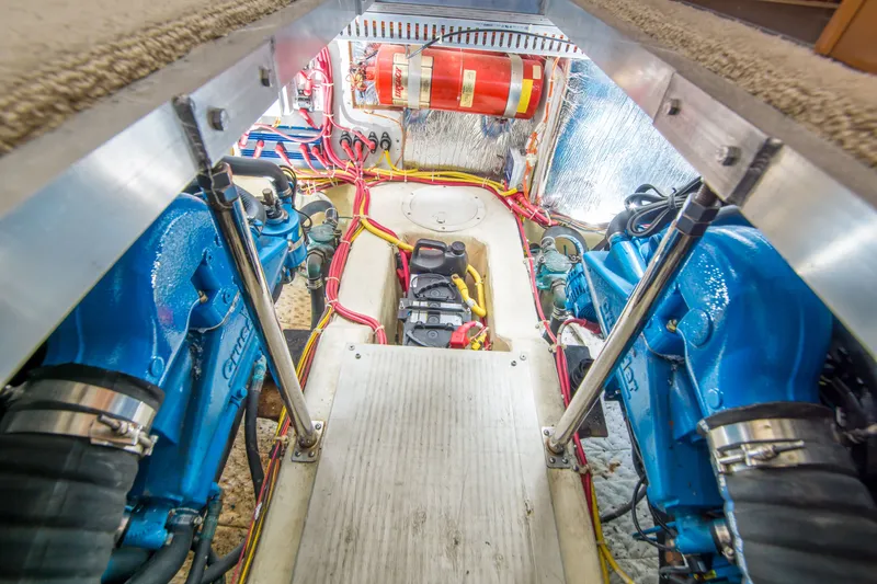 Slide: The Image of Engine room of a 2006 Carver 33 Super Sport with blue engines and wiring. - 30