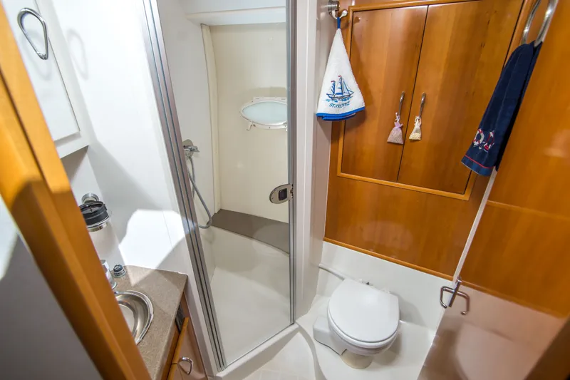 Slide: The Image of Bathroom interior of 2006 Carver 33 Super Sport yacht with shower and wooden cabinets. - 28