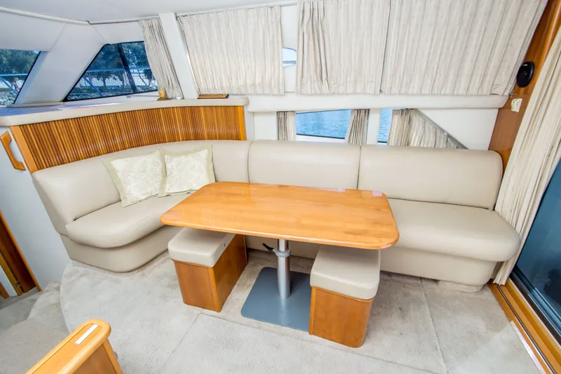 Slide: The Image of Interior of 2006 Carver 33 Super Sport yacht with beige seating and wooden table. - 20