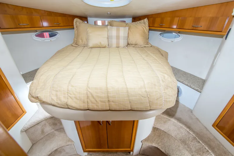 Slide: The Image of Luxurious cabin interior of 2006 Carver 33 Super Sport yacht with cozy bed and wood accents. - 26
