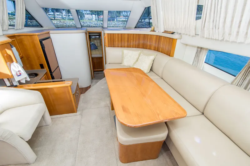 Slide: The Image of Luxurious interior of 2006 Carver 33 Super Sport yacht with elegant seating and dining area. - 17