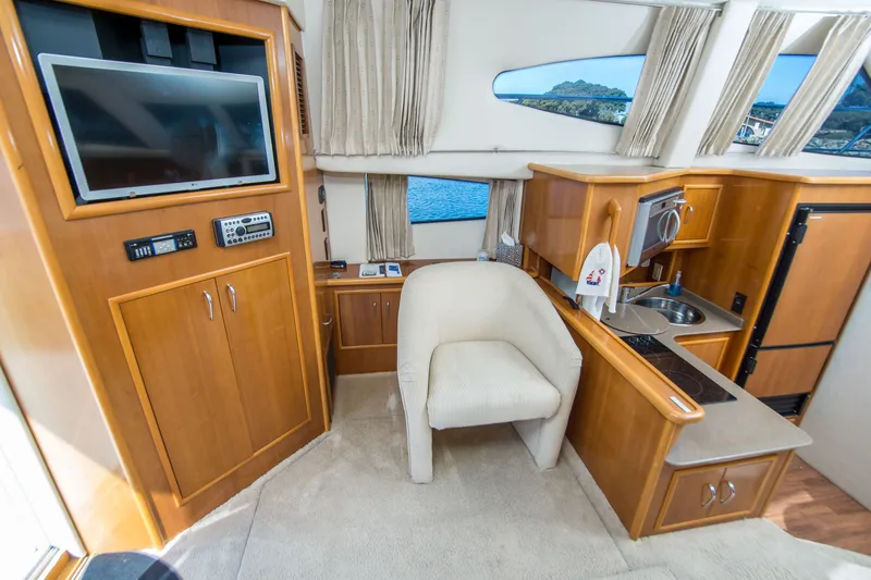 Slide: The Image of Interior of 2006 Carver 33 Super Sport yacht with kitchen and seating area. - 19