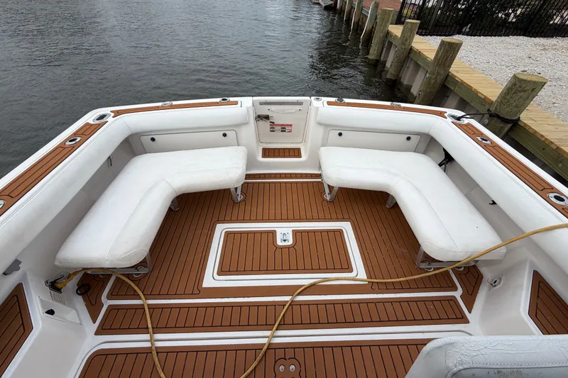 Slide: The Image of 2001 Tiara Yachts 2900 Coronet boat deck with white seating and wooden flooring. - 17