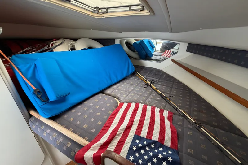 Slide: The Image of Interior cabin of 2001 Tiara Yachts 2900 Coronet with fishing rods and American flag. - 15