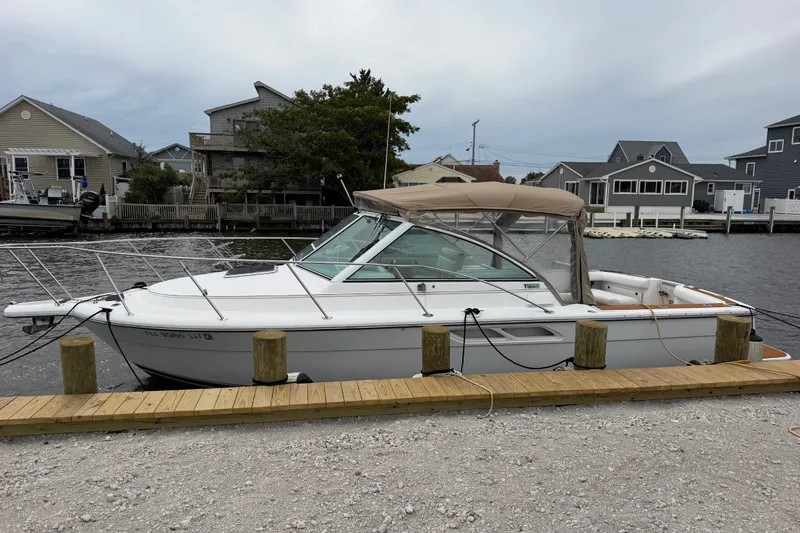 Slide: The Image of 2001 Tiara Yachts 2900 Coronet docked by waterfront homes. - 23