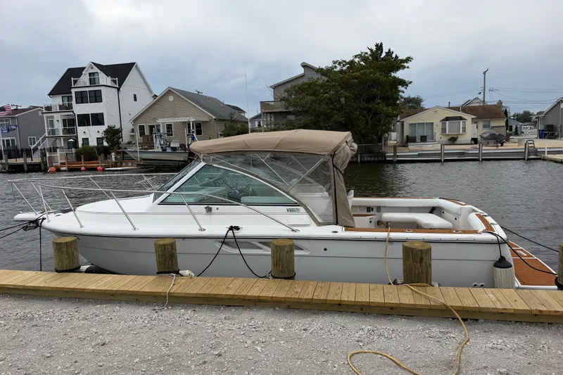 Slide: The Image of 2001 Tiara Yachts 2900 Coronet docked by waterfront homes. - 22