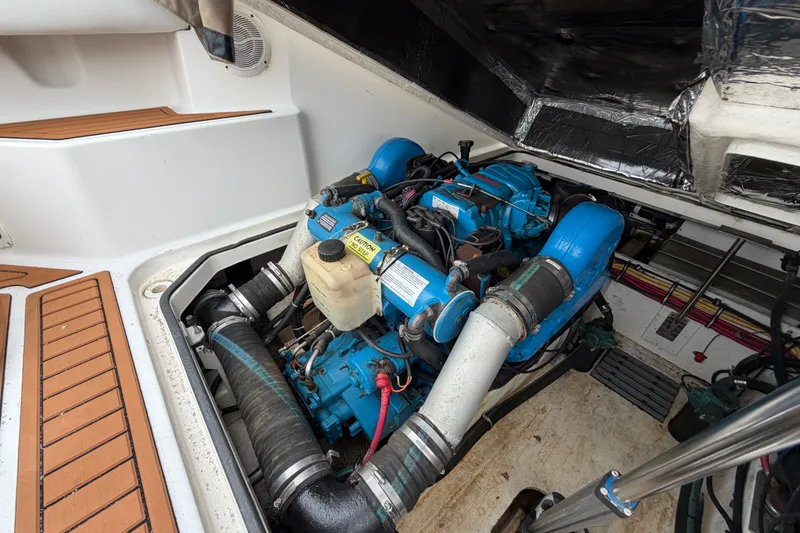 Slide: The Image of Engine compartment of a 2001 Tiara Yachts 2900 Coronet, showcasing a blue marine engine. - 19