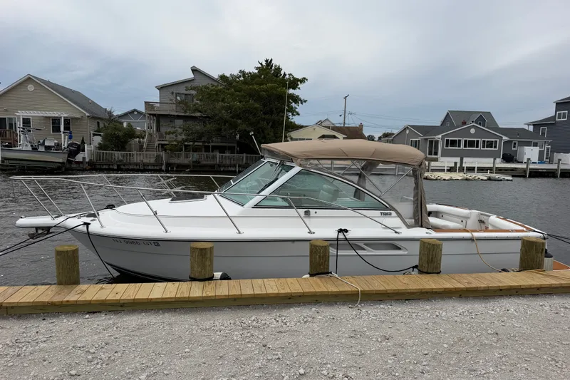 Slide: The Image of 2001 Tiara Yachts 2900 Coronet docked by waterfront homes. - 20