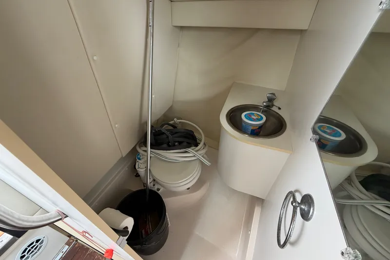 Slide: The Image of 2001 Tiara Yachts 2900 Coronet bathroom with sink and storage items. - 16